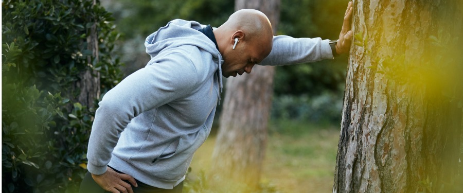 Black man struggling with asthma attack while jogging