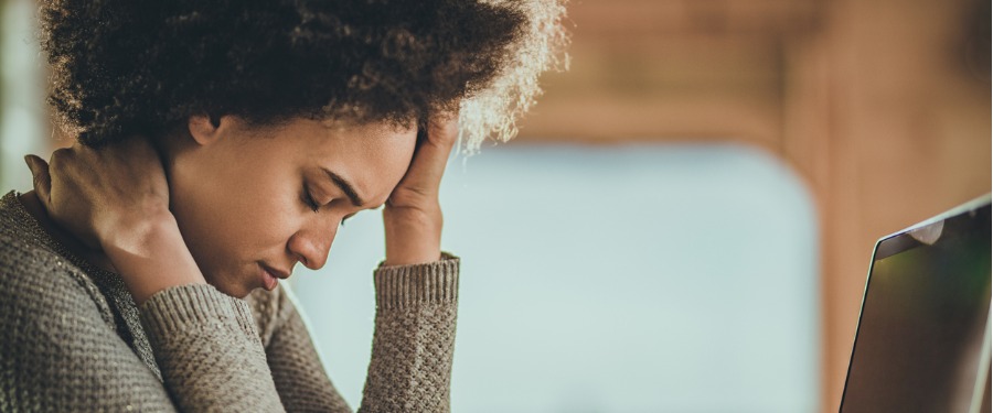 Black woman struggling with a headache due to lupus