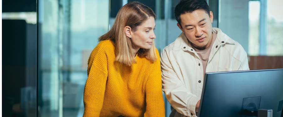 Woman and man looking at computer screen