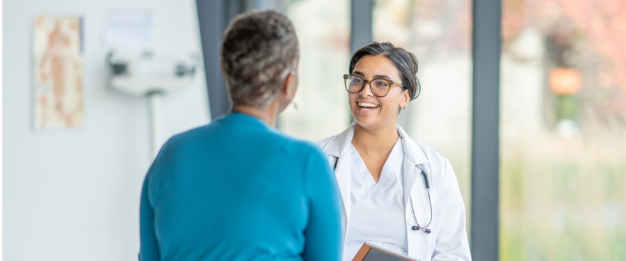 PBC patient discussing clinical trials with female doctor