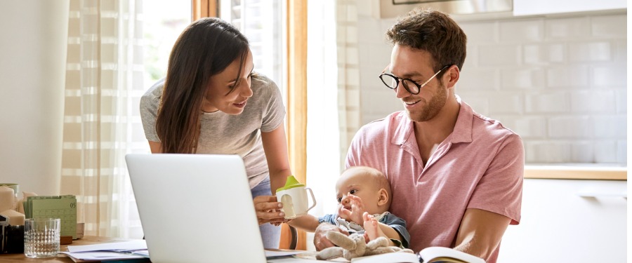 Parents playing with young baby at table