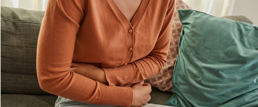 Female Crohn's patient holding stomach