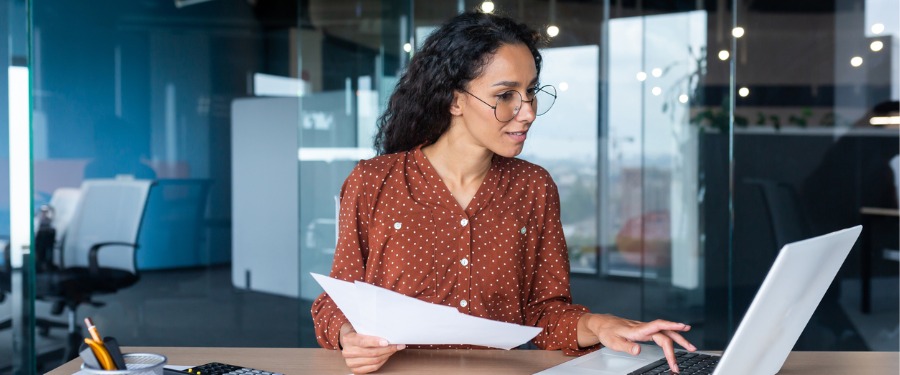 Woman in glasses working on annotating clinical trials