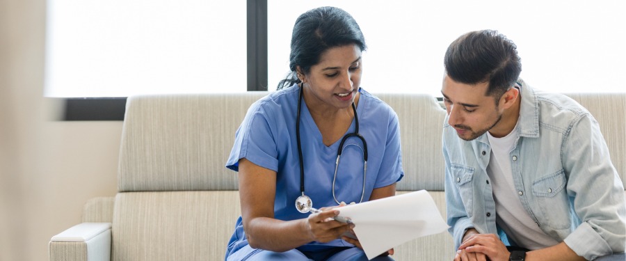 Female doctor discussing the importance health literacy with a male patient