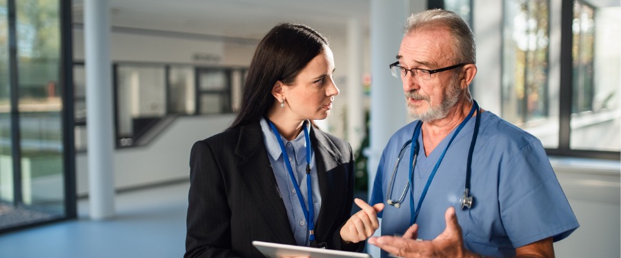 Woman and man discussing clinical trial site management